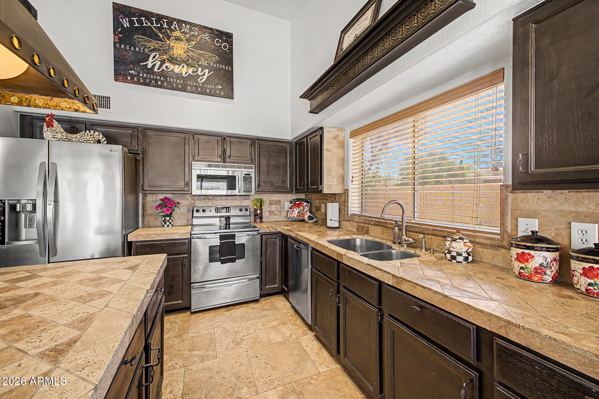 3948 North Ranier Mesa, AZ 85215 - Photo 21 of 69 a kitchen with stainless steel appliances granite countertop a sink stove and refrigerator
