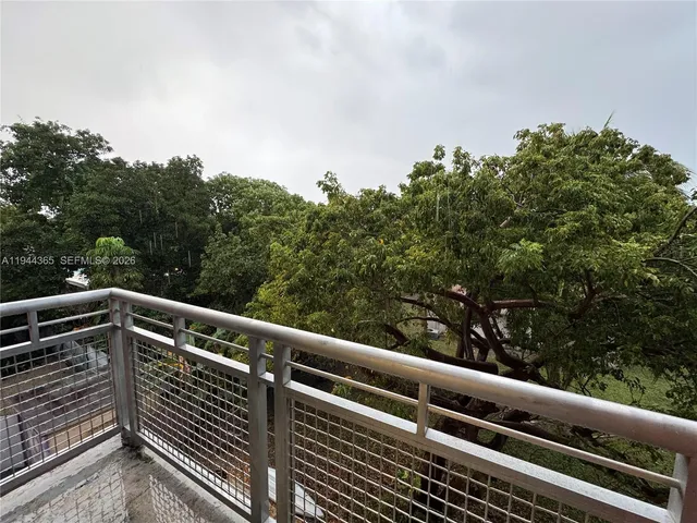 a view of balcony with wooden floor and fence