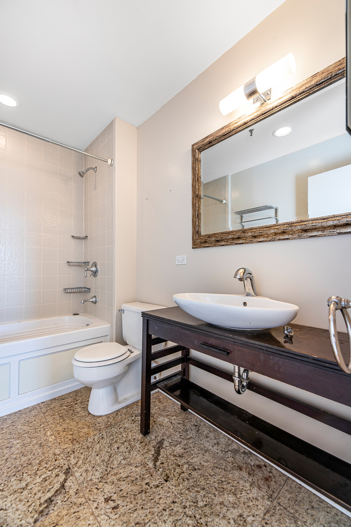 312 North May Street, Unit 5F Chicago, IL 60607 - Photo 13 of 16 a bathroom with a toilet sink a mirror and bathtub