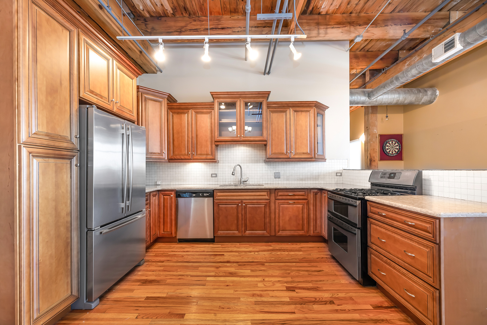 312 North May Street, Unit 5F Chicago, IL 60607 - Photo 6 of 16 a kitchen with stainless steel appliances granite countertop a sink a stove and refrigerator