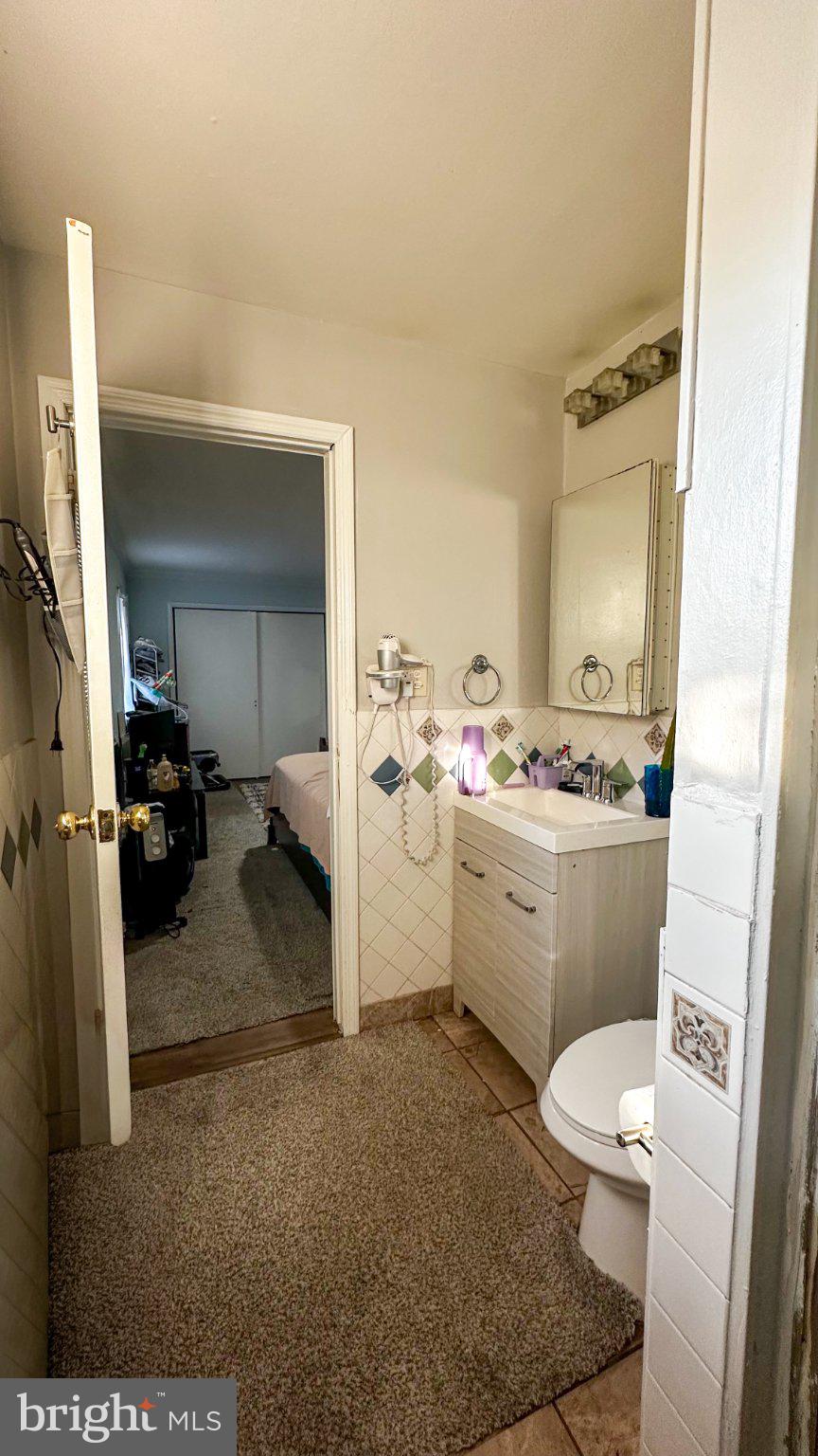 910 Magnolia Avenue Croydon, PA 19021 - Photo 16 of 23 a bathroom with a sink a toilet and a mirror