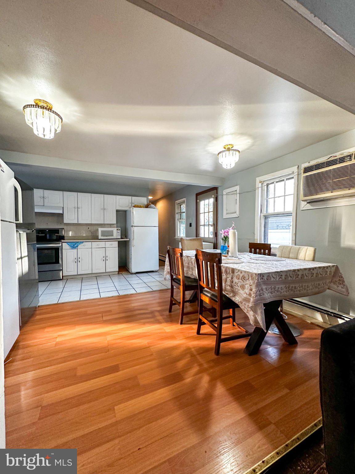 910 Magnolia Avenue Croydon, PA 19021 - Photo 5 of 23 a view of a dining room with furniture a kitchen and chandelier