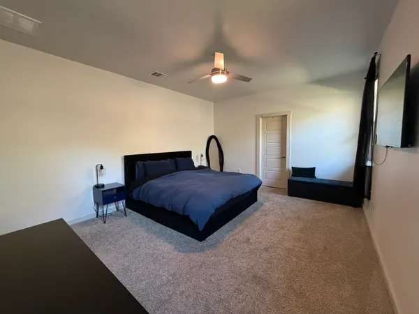a bedroom with a bed and a chandelier