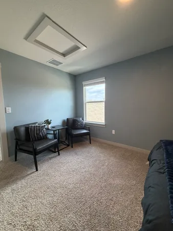 a living room with furniture and a window