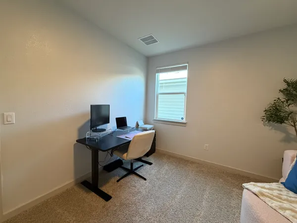a view of a workspace with furniture