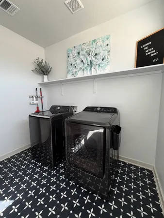 a utility room with a sink a cabinets and appliances