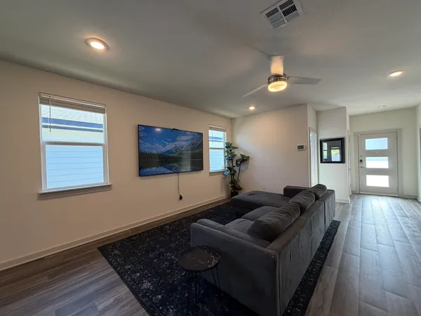 a living room with furniture and a flat screen tv