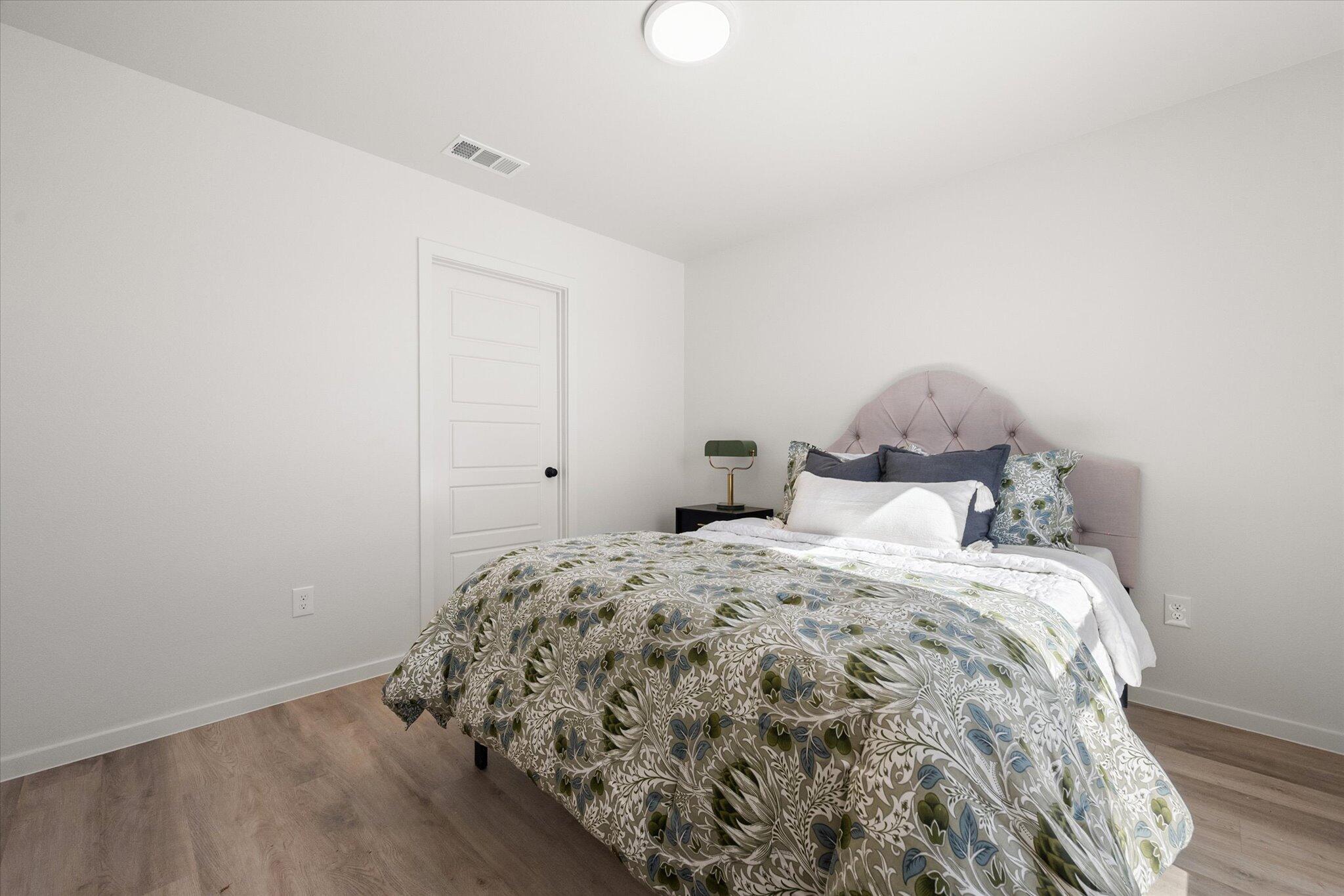 5506 Smith Street Lubbock, TX 79416 - Photo 12 of 16 a bedroom with a bed and a window