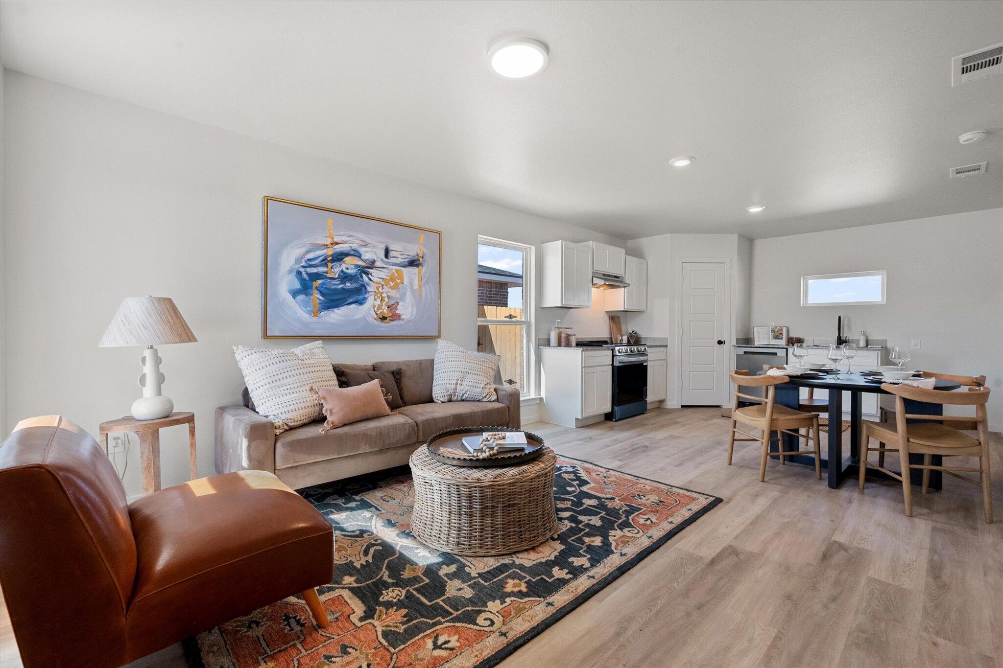 5506 Smith Street Lubbock, TX 79416 - Photo 3 of 16 a living room with furniture a dining table and a fireplace