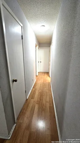 an entryway of a house with wooden floor