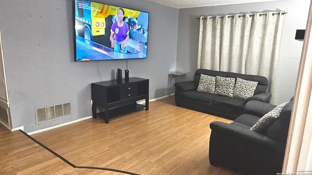 a living room with furniture rug and window