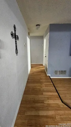 a view of a hall with wooden floor