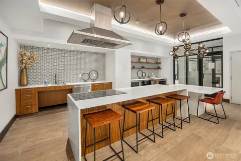 a large kitchen with a table and chairs