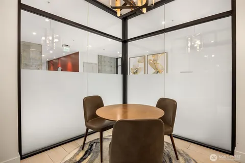 a dining room with furniture and wooden floor