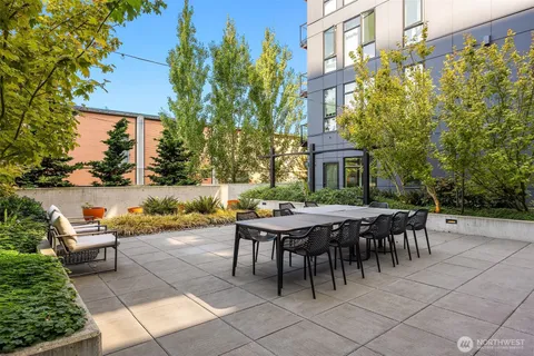 a backyard of a house with table and chairs