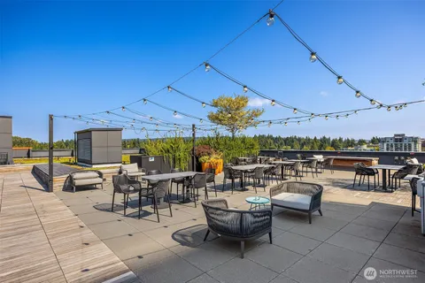 a view of a patio with dining table and chairs