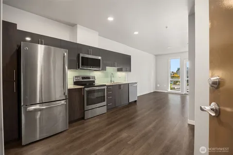 a kitchen with a refrigerator and a sink