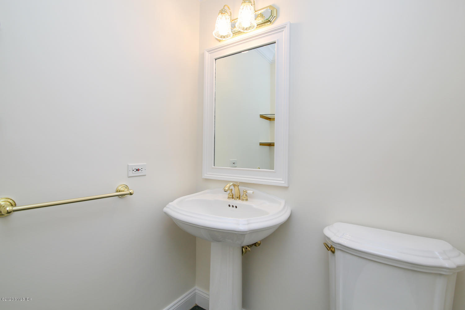 40 West Elm Street, Unit 3M Greenwich, CT 06830 - Photo 11 of 19 a bathroom with a sink a toilet and mirror
