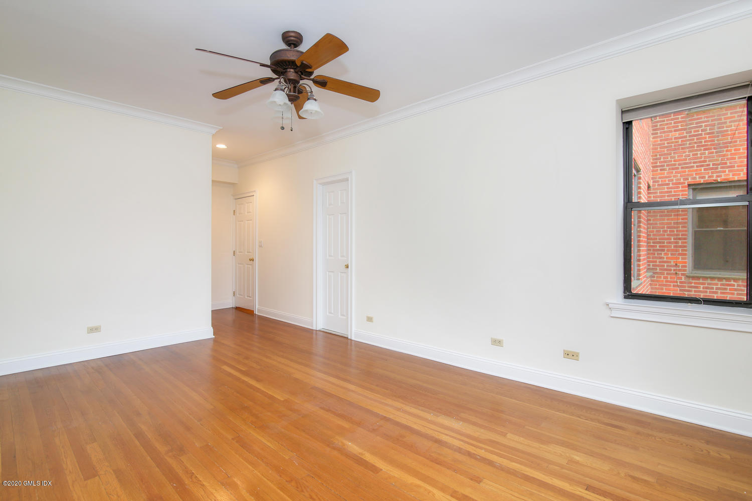 40 West Elm Street, Unit 3M Greenwich, CT 06830 - Photo 14 of 19 an empty room with a window and a ceiling fan