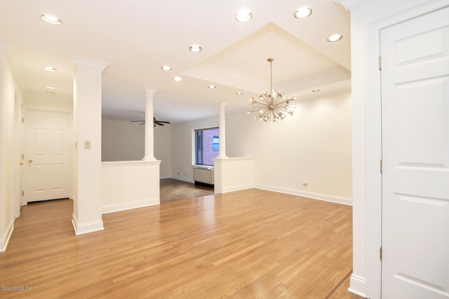40 West Elm Street, Unit 3M Greenwich, CT 06830 - Photo 3 of 19 wooden floor in an empty room with a window
