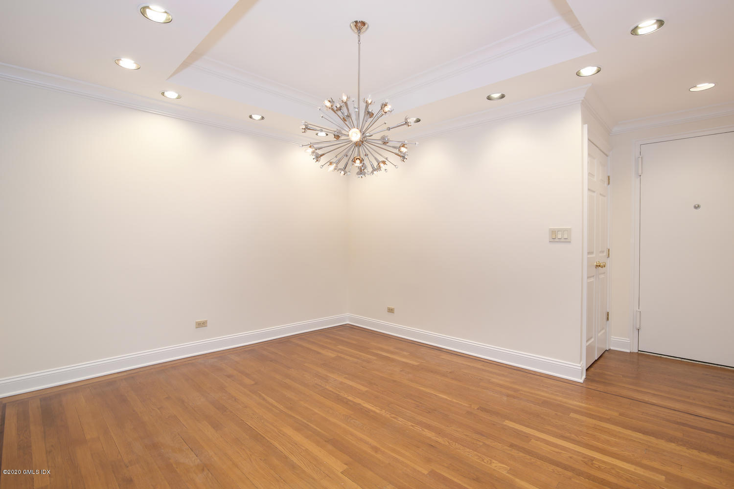 40 West Elm Street, Unit 3M Greenwich, CT 06830 - Photo 4 of 19 wooden floor in an empty room with a window