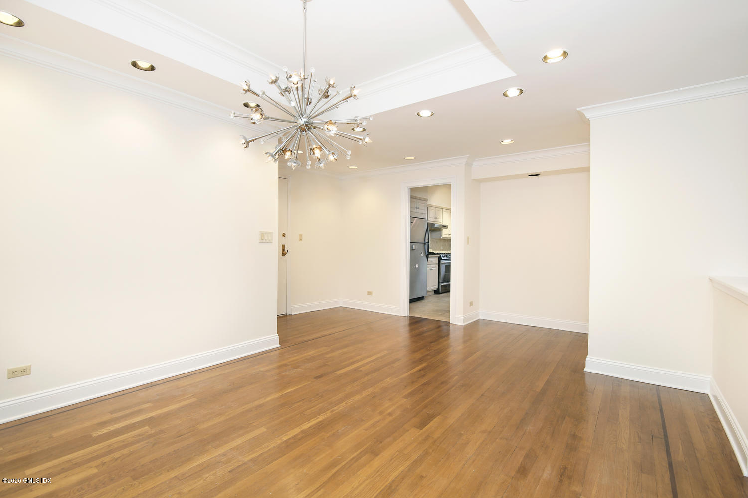 40 West Elm Street, Unit 3M Greenwich, CT 06830 - Photo 5 of 19 an empty room with wooden floor and ceiling fan