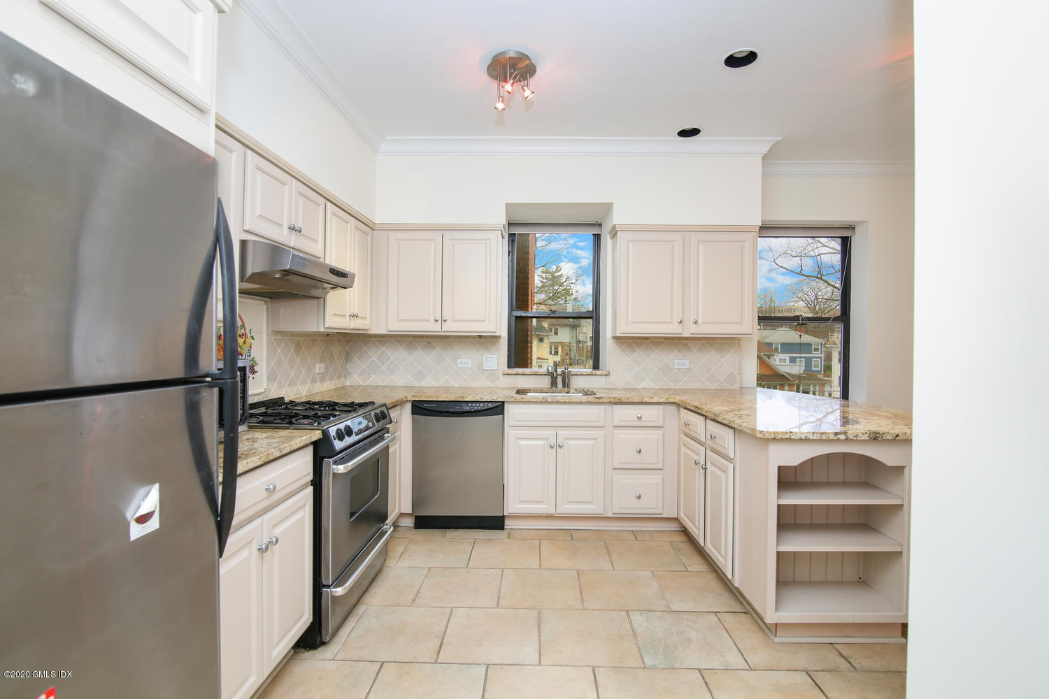 40 West Elm Street, Unit 3M Greenwich, CT 06830 - Photo 9 of 19 a kitchen with granite countertop stainless steel appliances a stove refrigerator sink and cabinets
