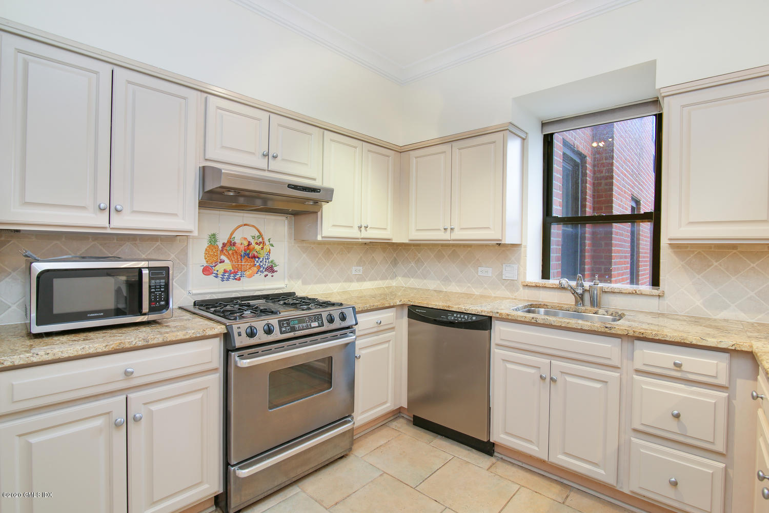 40 West Elm Street, Unit 3M Greenwich, CT 06830 - Photo 10 of 19 a kitchen with white cabinets and appliances