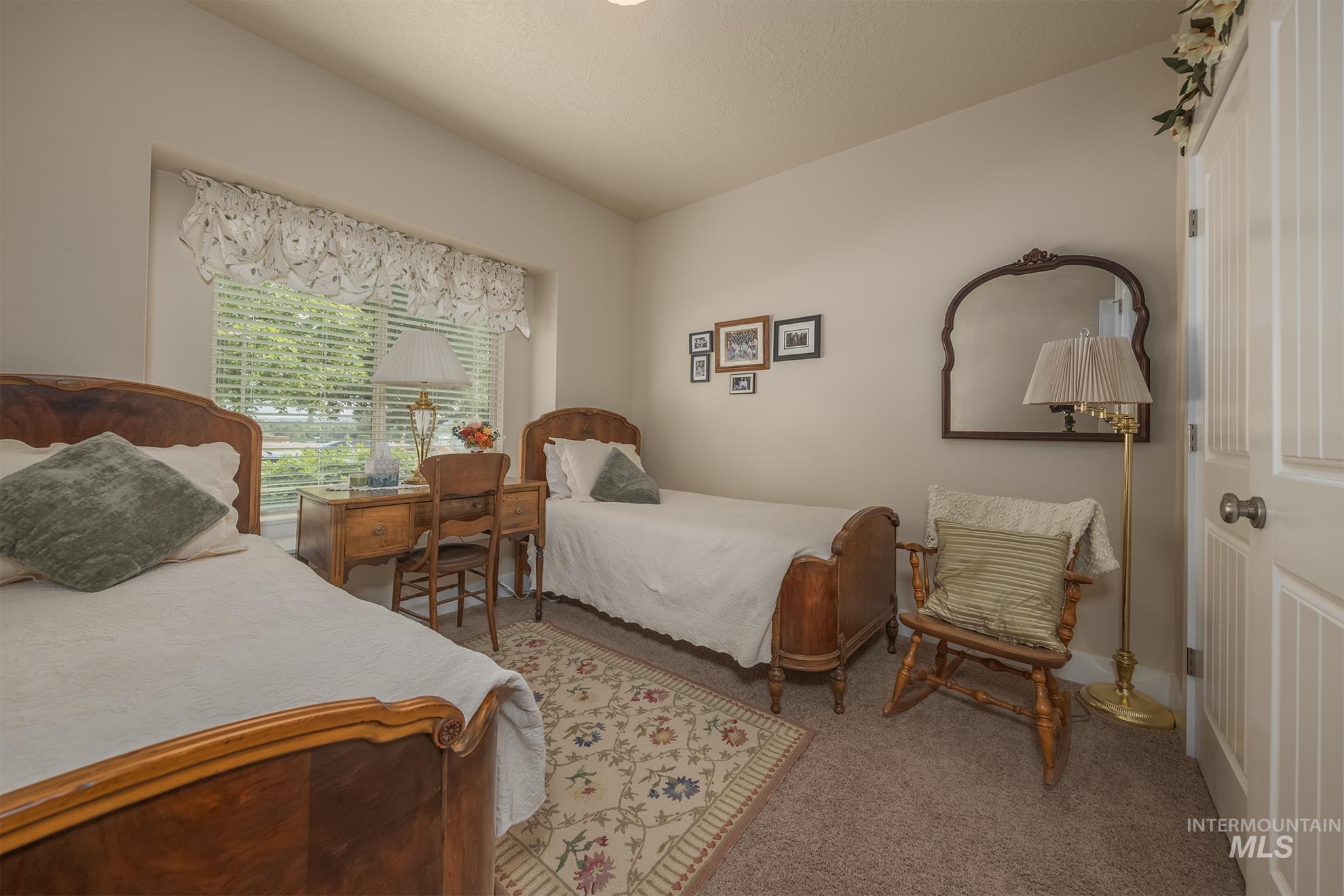 420 West Indianhead Road Weiser, ID 83672 - Photo 17 of 40 Carpeted room featuring a large window with blinds, light-toned walls, and a white paneled door
