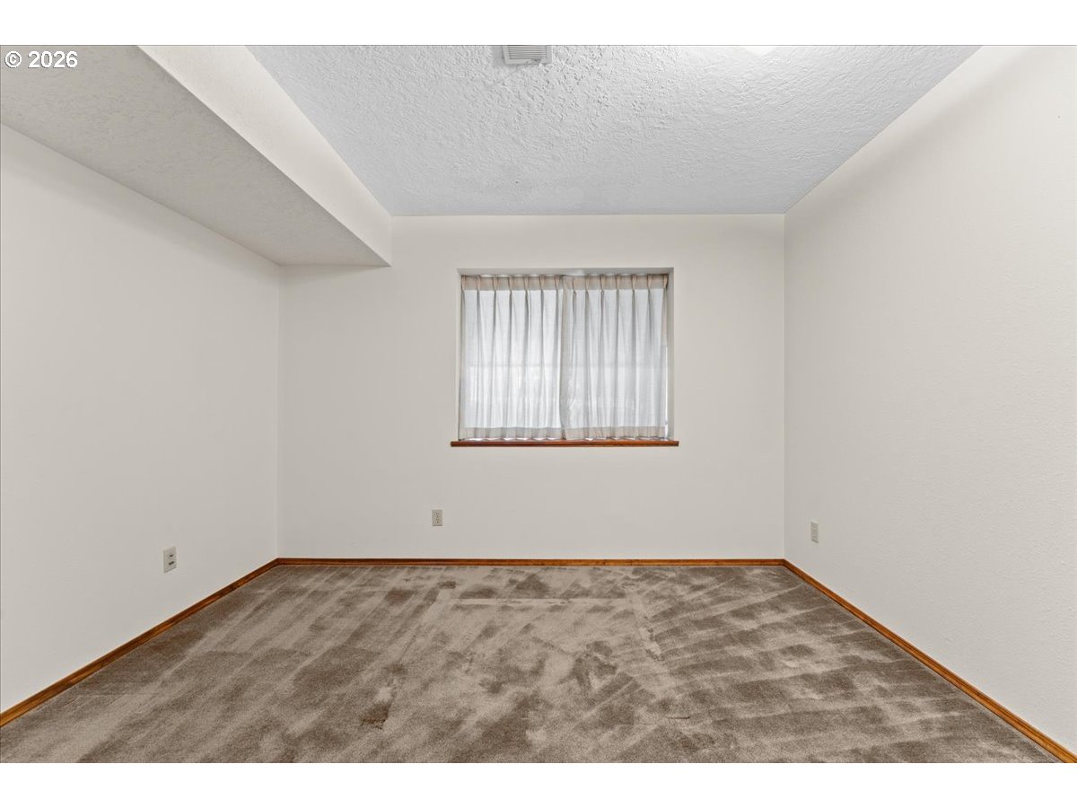 17501 Northeast Clackamas Street Portland, OR 97230 - Photo 30 of 38 an empty room with wooden floor and windows