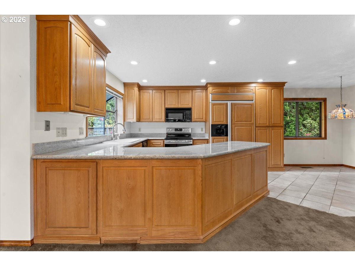 17501 Northeast Clackamas Street Portland, OR 97230 - Photo 3 of 38 a kitchen with stainless steel appliances granite countertop a sink a stove a microwave a counter top space and cabinets