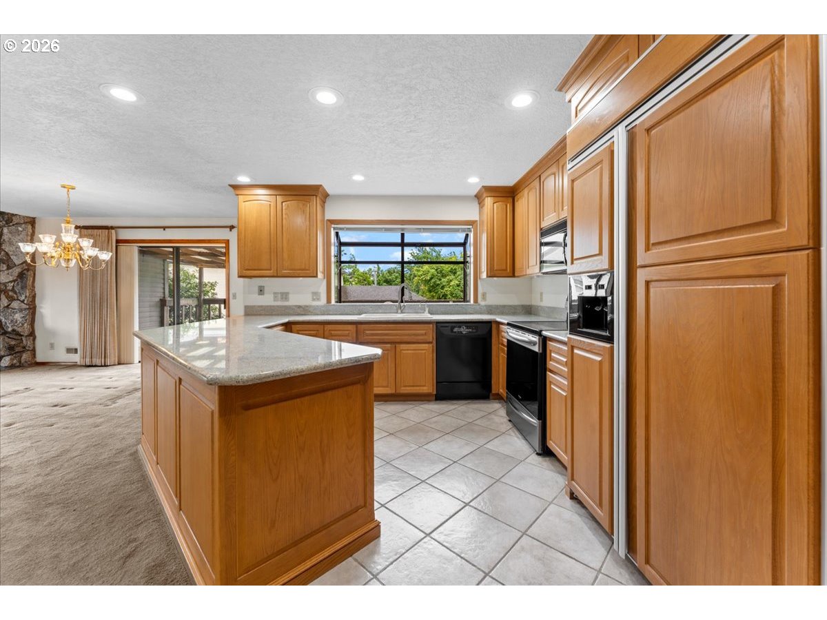 17501 Northeast Clackamas Street Portland, OR 97230 - Photo 5 of 38 a kitchen with stainless steel appliances granite countertop a sink a stove and a refrigerator