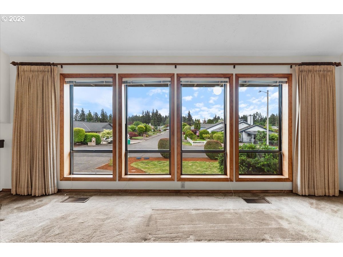 17501 Northeast Clackamas Street Portland, OR 97230 - Photo 6 of 38 an empty room with wooden floor and windows