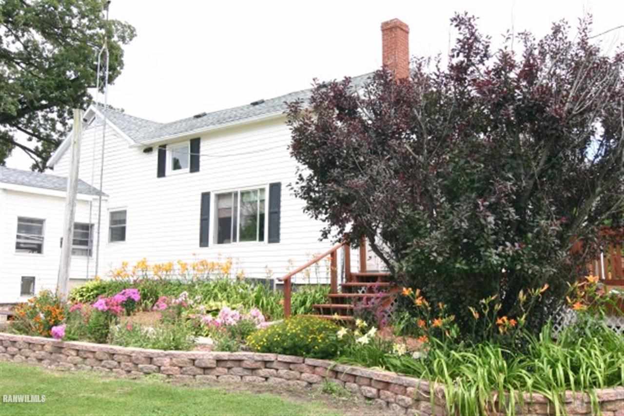 6031 West Kermit Road Freeport, IL 61032 - Photo 2 of 12 a front view of a house with a yard and potted plants