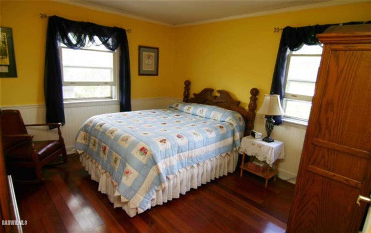 6031 West Kermit Road Freeport, IL 61032 - Photo 7 of 12 a bedroom with a bed and wooden floor