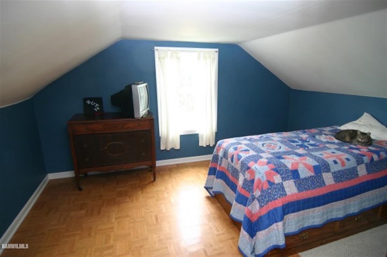 6031 West Kermit Road Freeport, IL 61032 - Photo 9 of 12 a bedroom with a bed and wooden floor