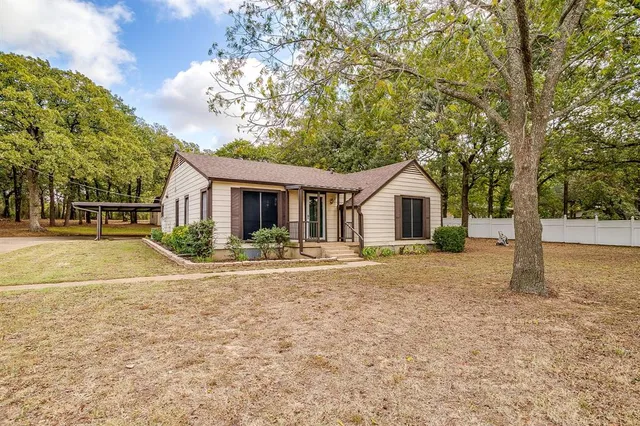 a front view of a house with yard and green space