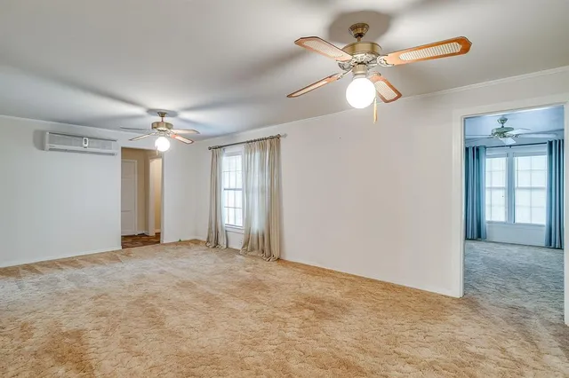 a view of an empty room with a ceiling fan