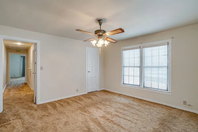 a view of a chandelier fan and a ceiling fan in a room