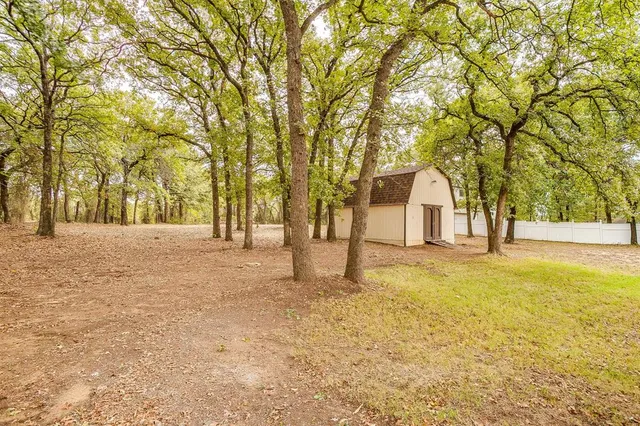 a view of a house with a yard and tree