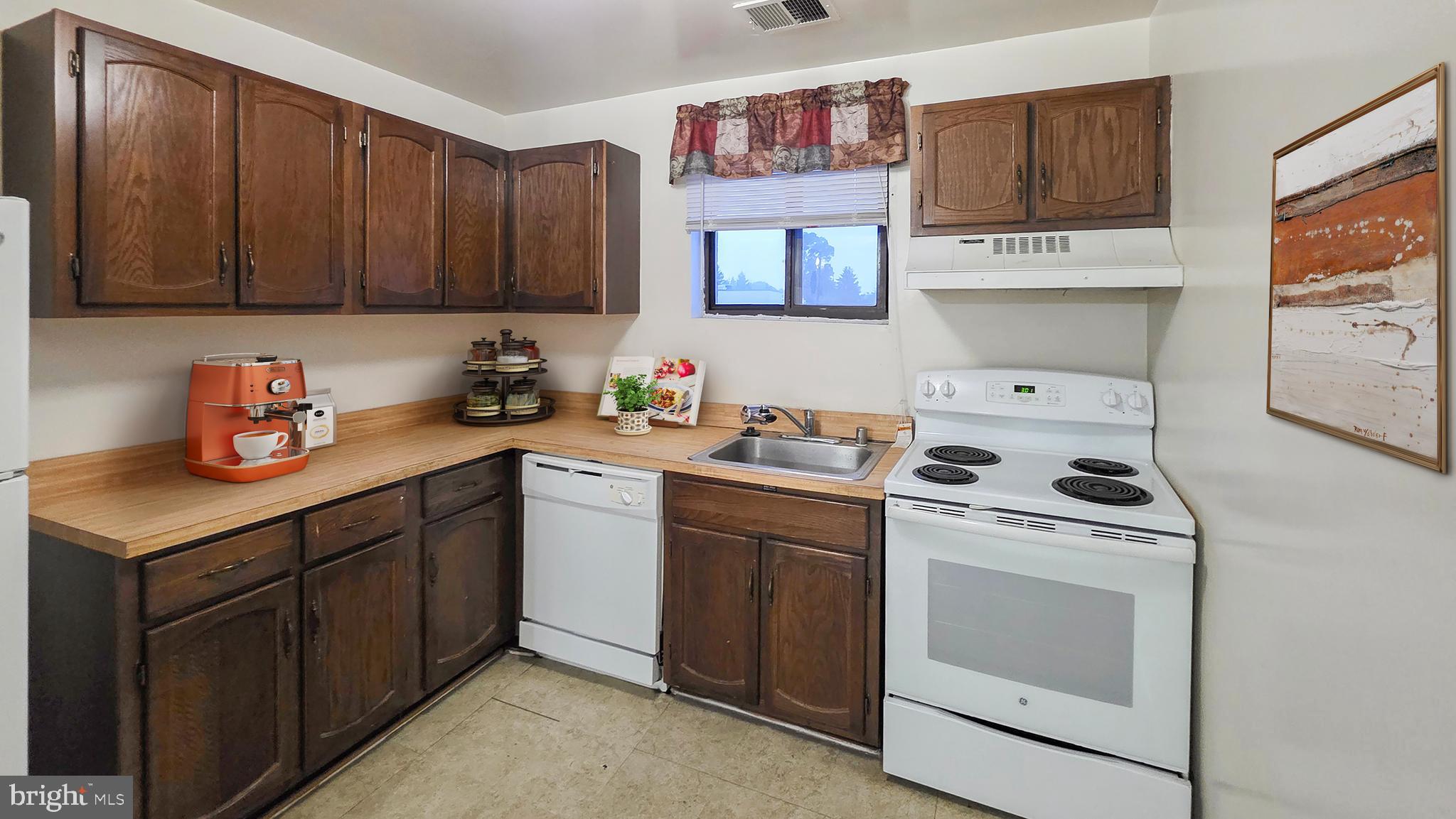 3928 Rolling Rd., Unit C10 Pikesville, MD 21208 - Photo 7 of 26 a kitchen with a sink cabinets and appliances