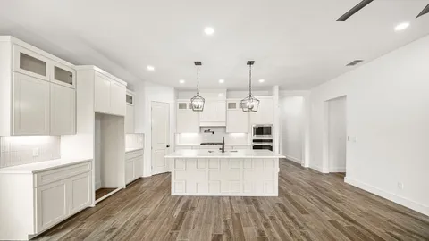 a large kitchen with a lot of counter space and stainless steel appliances