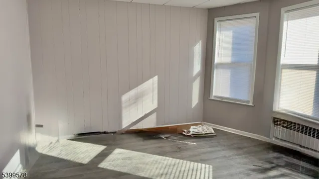 a view of a livingroom with wooden floor and a window