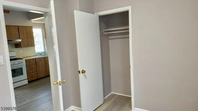 a view of hallway with wooden floor