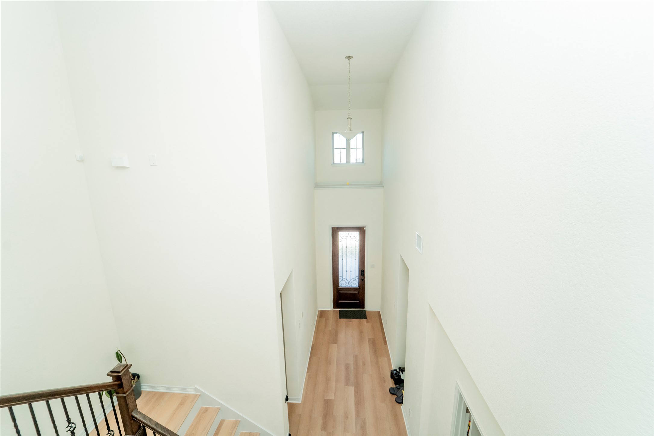 20813 Carries Ranch Road Pflugerville, TX 78660 - Photo 12 of 29 Hall featuring a high ceiling, light wood-style flooring, plenty of natural light, and an upstairs landing