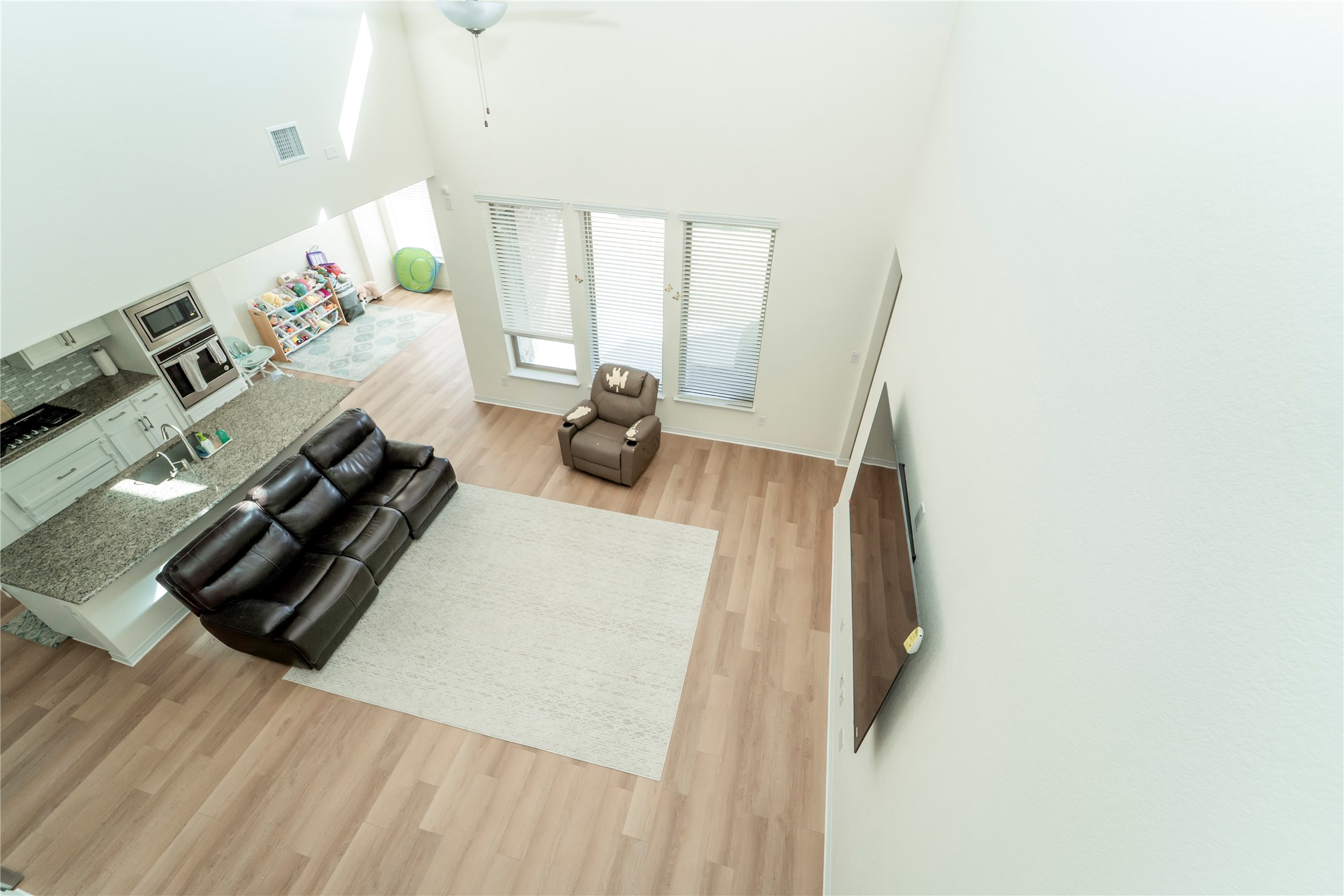20813 Carries Ranch Road Pflugerville, TX 78660 - Photo 15 of 29 Living area with light wood-style floors, a ceiling fan, and a high ceiling