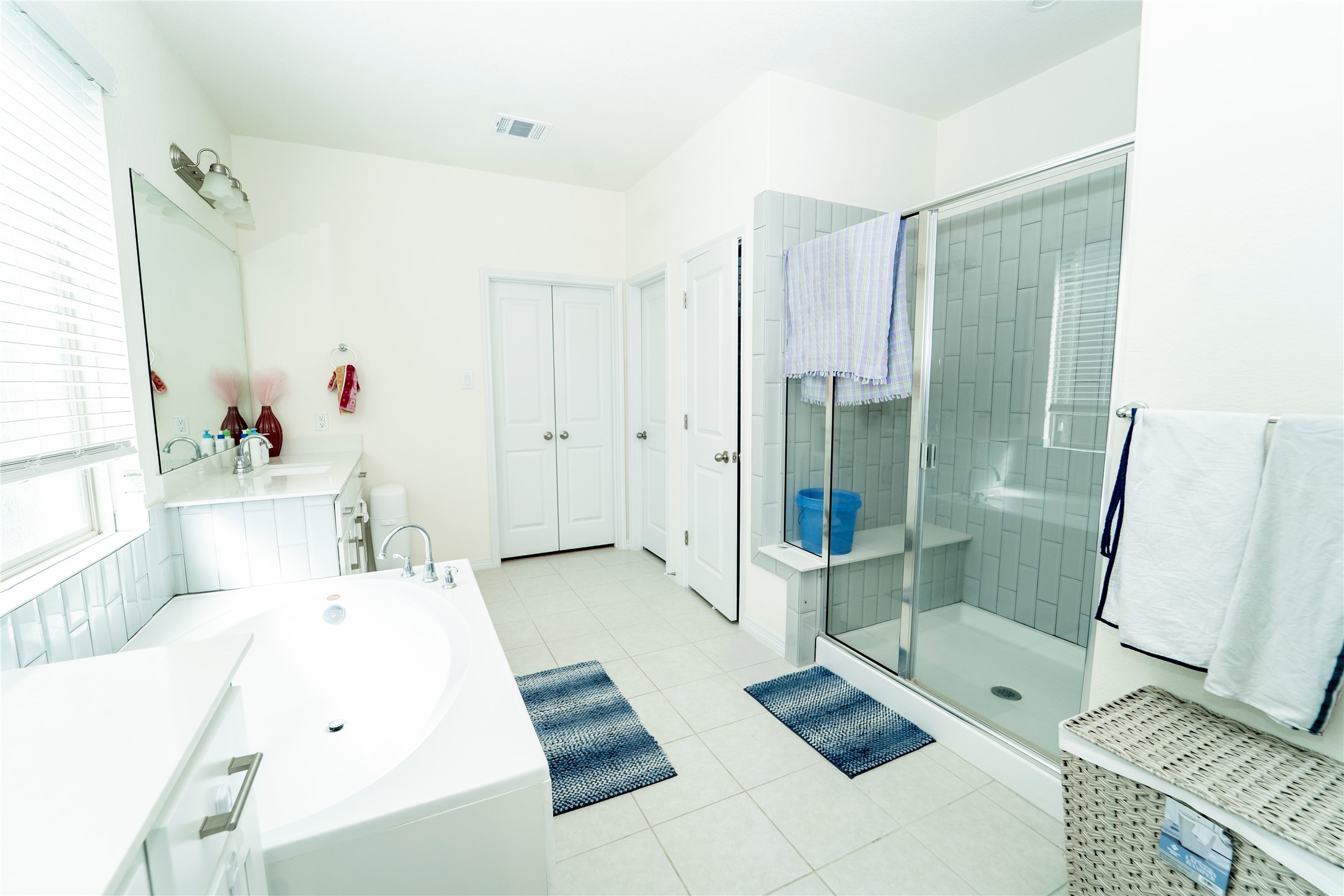 20813 Carries Ranch Road Pflugerville, TX 78660 - Photo 16 of 29 Bathroom with vanity, a shower stall, a garden tub, and light tile patterned floors