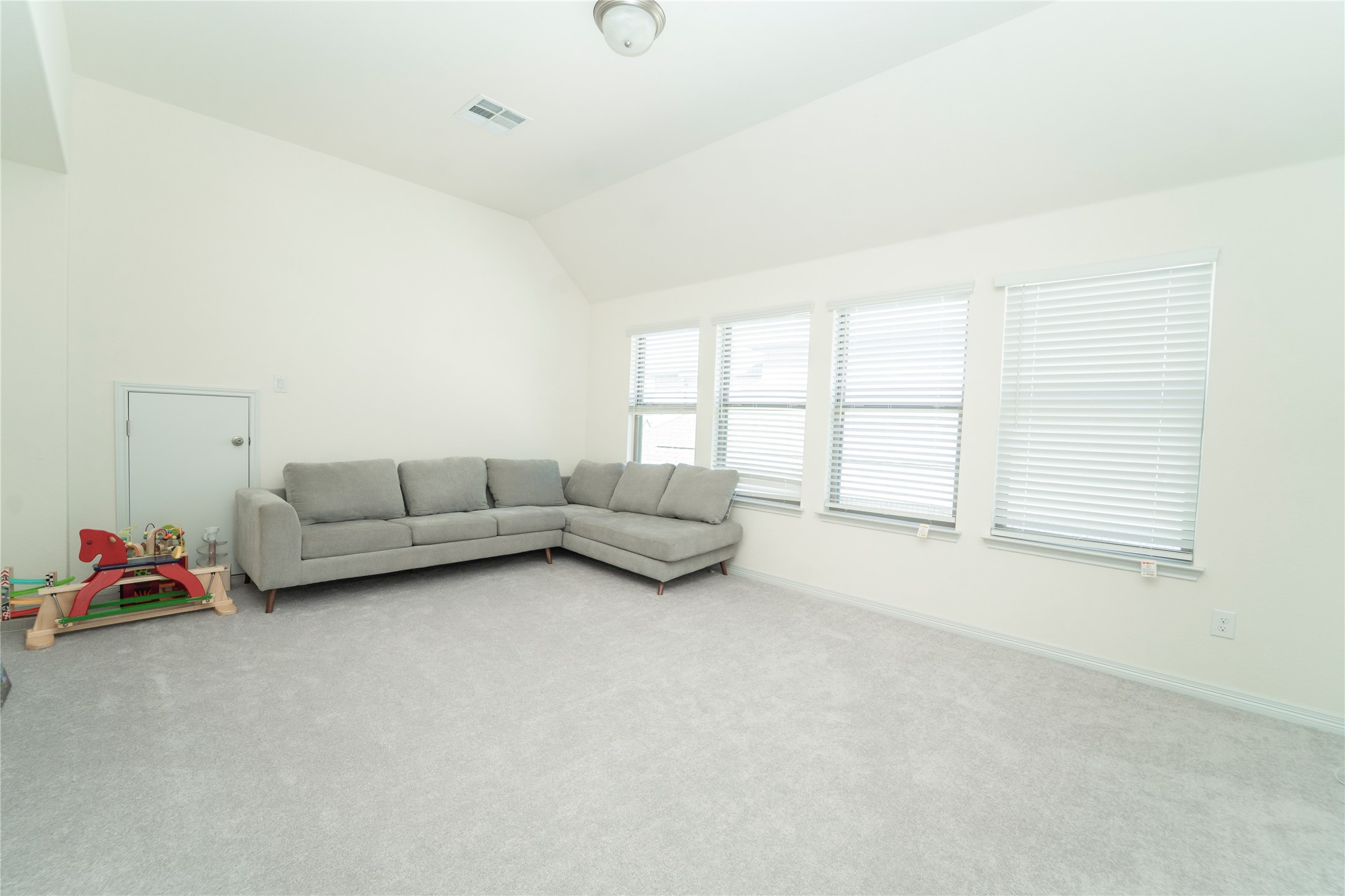 20813 Carries Ranch Road Pflugerville, TX 78660 - Photo 23 of 29 Living room featuring lofted ceiling and carpet floors