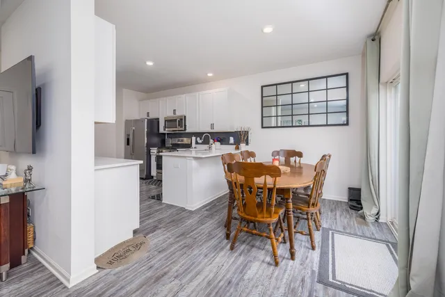 a view of a dining room with furniture and wooden floor