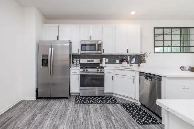 a kitchen with a sink stove and refrigerator